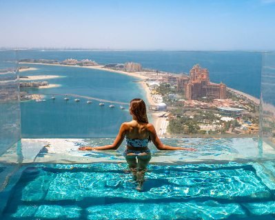 tourists enjoying the views of burj khalifa, burj al aran, blue waters island , palm island, down town dubai, old dubai, historical dubai, with abra rides on dubai creek on CITY TOUR DESERT SAFARI FROM ROYAL ATLANTIS