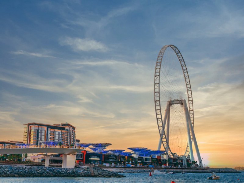 tourist enjoying dune bashing, camel rides, bbq , desert safari and enjoying views of palm island, burj al arab, bluewaters island on dubai city tour and desert safari combo