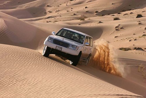 tourists enjoying desert safari with belly dance, bbq dinner and dubai city tour with burj khalifa views, palm island, blue waters island, atlantis and royal atlantis on City tour desert safari from Hilton Dubai Marina