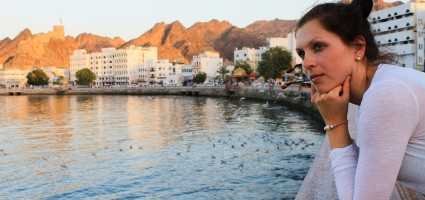 a female tourist in oman , enoying the views of muttrah corniche, muttrah souk, mutrah fort, sultan qaboos mosque, royal opera house, al alams palace on solo trip to oman from dubai