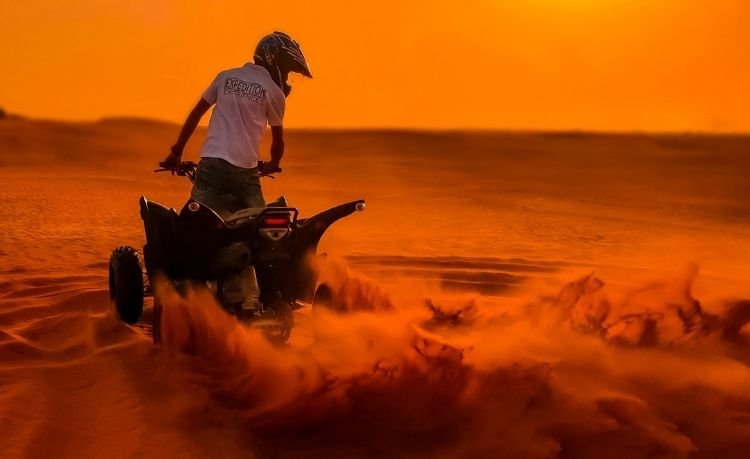 tourist enjoying high octane rides on the ras al khaimah dunes in brand new quad/atv on a