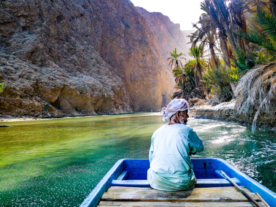 tourists enjoying the swim in wadi shab, bimmah sinkhole, grand qaboos mosque, muttrah souk, muttrah corniche , mirani fort, alam palace, jalali fort, royal opera house on Oman 2 Days 1 night Tour From Dubai
